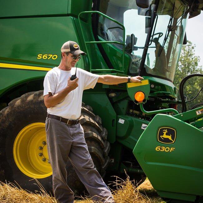 Jaindl farm worker with John Deere